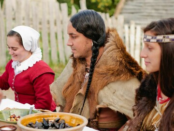 Wampanoag People share a feast with Pilgrims