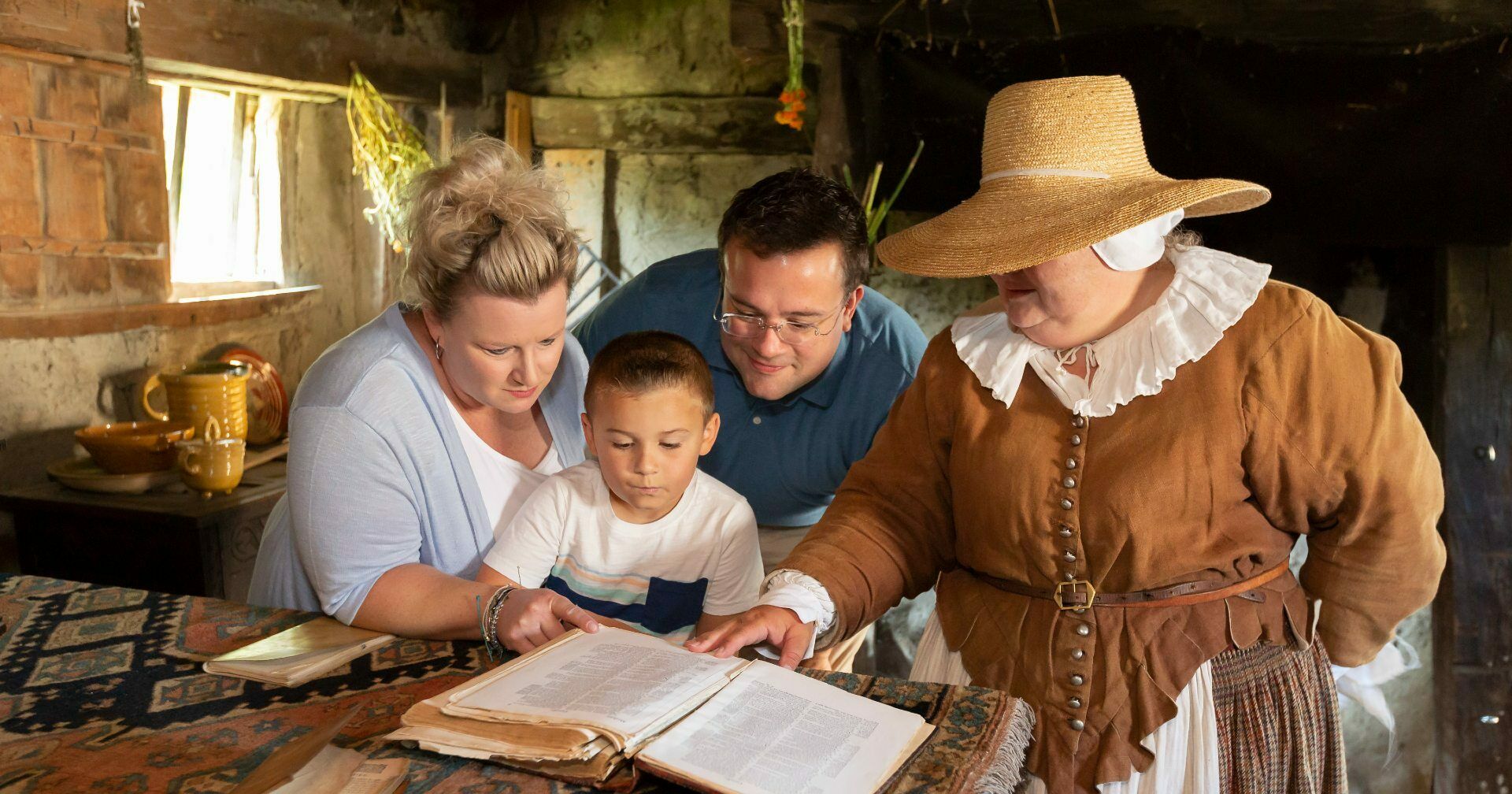 Family reading alongside Pilgrim