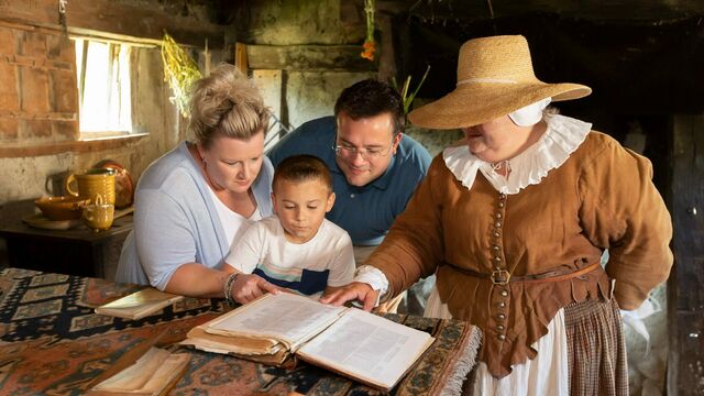 Family reading alongside Pilgrim