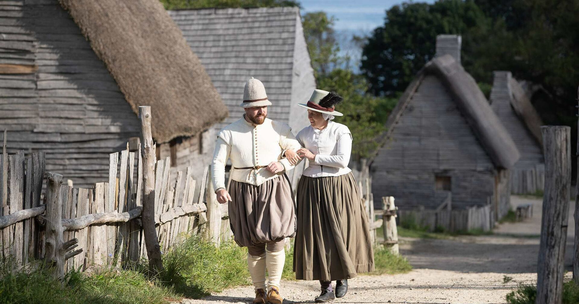 Pilgrim couple walks down village path