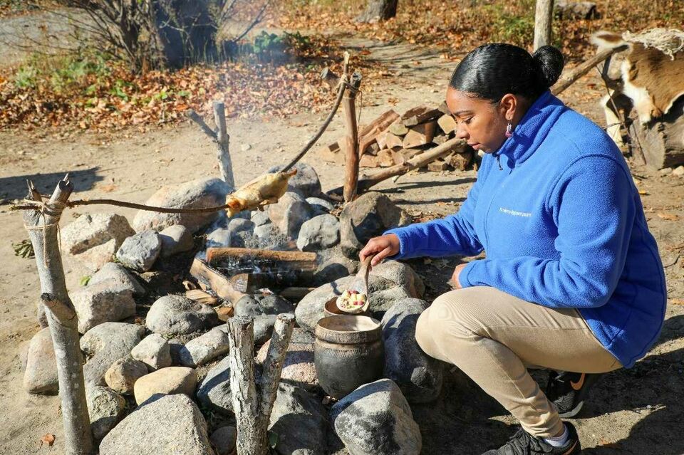 Woman cooking over a fire