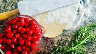 Cranberries rosemary rolling pin on counter