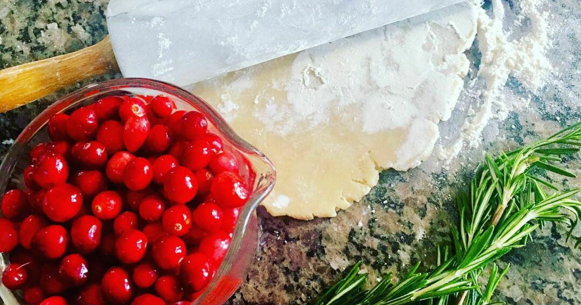 Cranberries rosemary rolling pin on counter