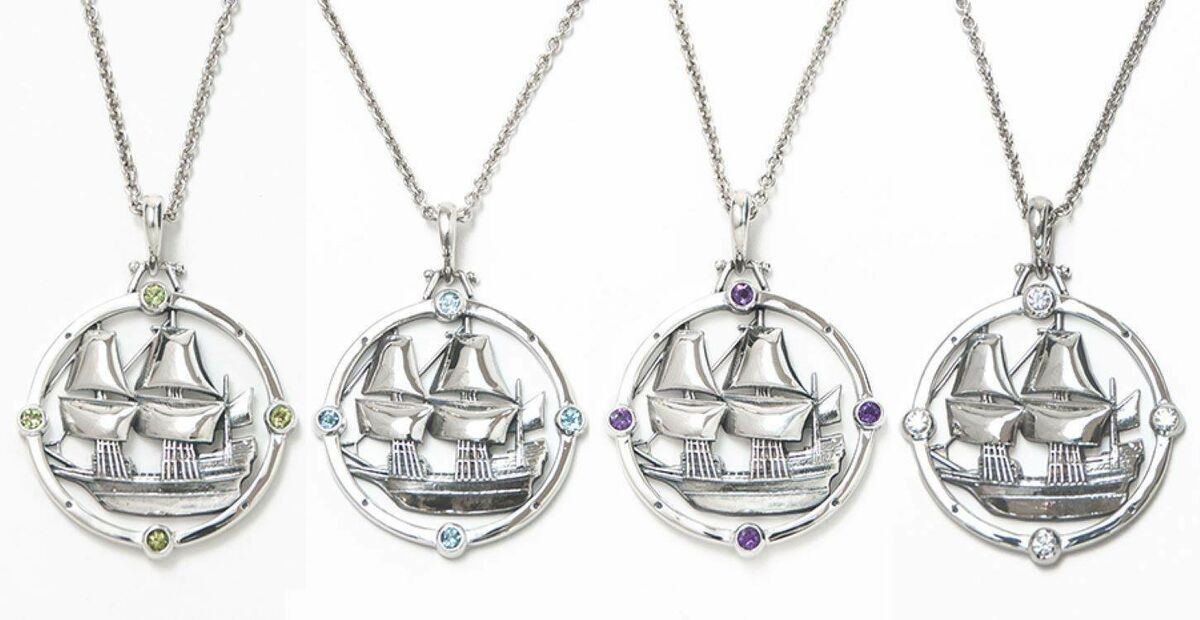 Four silver pendants with tall ship in center