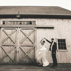 bride and groom near barn